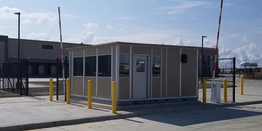 A modular gate house installed at an industrial facility entrance.