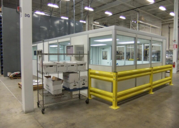 A modular in-plant office with a yellow guard rail.