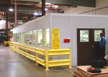 An in-plant office with a yellow guard rail.