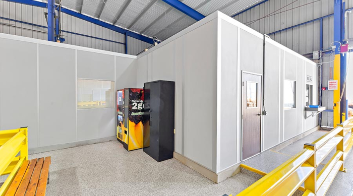 In-plant office with vending machines outside of it.