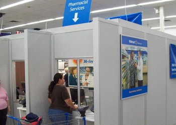 Modular pharmacy enclosure by Allied Modular inside a retail store, featuring service windows and private office space.