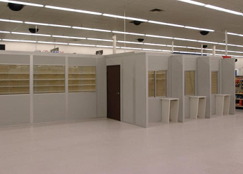 Modular retail buildings by Allied Modular inside a store, featuring prefabricated walls, windows, and service counters.