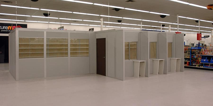 Modular retail buildings by Allied Modular inside a store, featuring prefabricated walls, windows, and service counters.