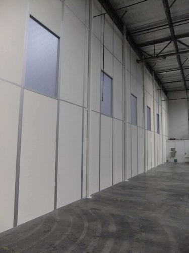 A tall demising wall system. Temporary walls for flexible space solutions.