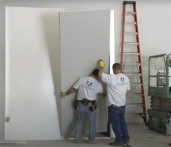 Installers put up a modular panel.