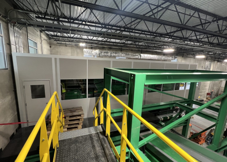 A modular mezzanine (catwalk) structure with safety railings in an industrial setting, designed to manage live loads effectively.