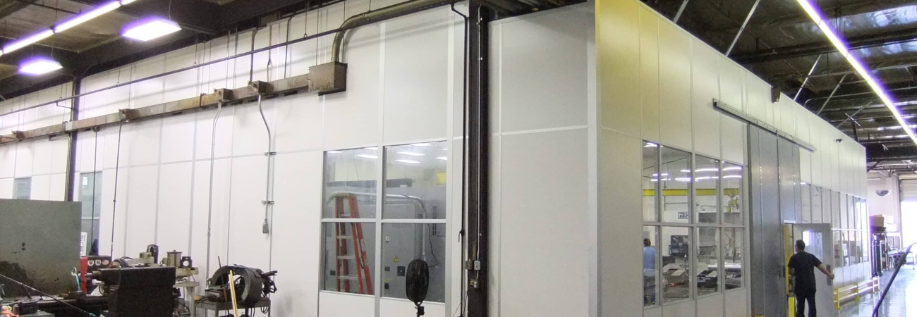 Modular machine enclosure built by Allied Modular inside an industrial facility.