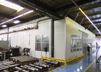 Modular machine enclosure built by Allied Modular inside an industrial facility.