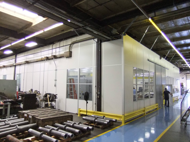 Modular machine enclosure built by Allied Modular inside an industrial facility.