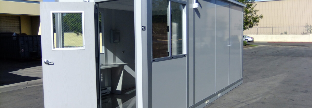 A compact modular shipping and receiving office with an open door and large windows, designed for efficient logistics operations.