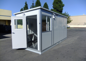 A compact modular shipping and receiving office with an open door and large windows, designed for efficient logistics operations.