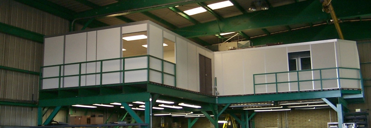 A modular mezzanine (catwalk) structure with safety railings in an industrial setting, designed to manage live loads effectively.