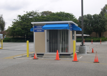 Custom guard shack with blue awning used as a visitor information center