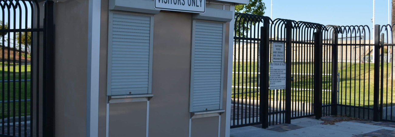 Allied Modular ticket booth at a sports venue entrance with roll-down service windows and security fencing