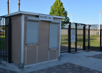 Allied Modular ticket booth at a sports venue entrance with roll-down service windows and security fencing