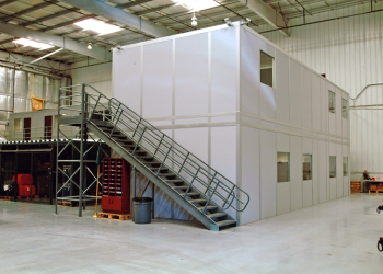 Two-story modular office building by Allied Modular, installed inside a warehouse with an external metal staircase.