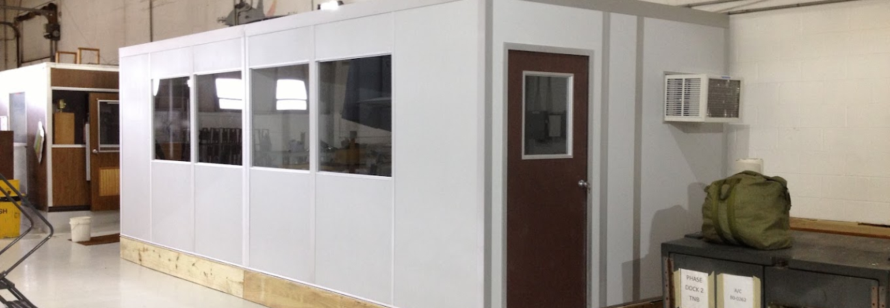 A modular cool down room installed in an industrial setting, featuring air conditioning, windows for visibility, and a secure door for controlled access. The space provides a cool environment where workers can take breaks and recover from heat exposure by allied modular building system - modular buildings