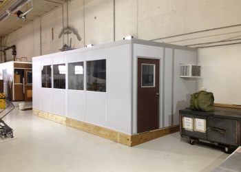 A modular cool down room installed in an industrial setting, featuring air conditioning, windows for visibility, and a secure door for controlled access. The space provides a cool environment where workers can take breaks and recover from heat exposure by allied modular building system - modular buildings