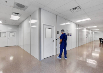 A technician entering one of Allied Modular’s controlled environment rooms designed for research and manufacturing applications.