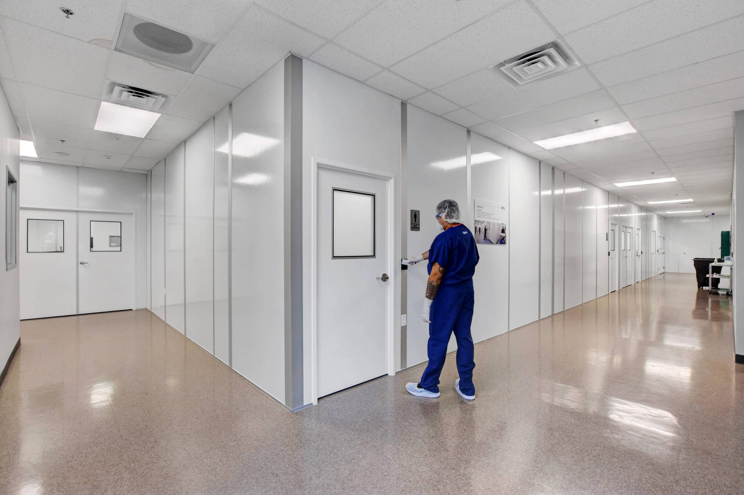 A technician entering one of Allied Modular’s controlled environment rooms designed for research and manufacturing applications.
