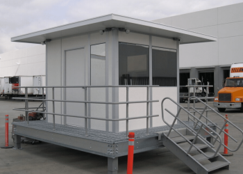 Custom guard shacks by Allied Modular with elevated platform and metal stairs.