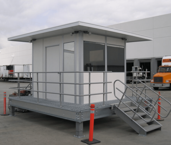Custom guard shacks by Allied Modular with elevated platform and metal stairs.