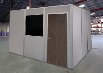 A quick-ship modular office by Allied Modular, installed inside a warehouse. The structure features a solid door, a window, and durable panel walls, providing a fast and efficient workspace solution.