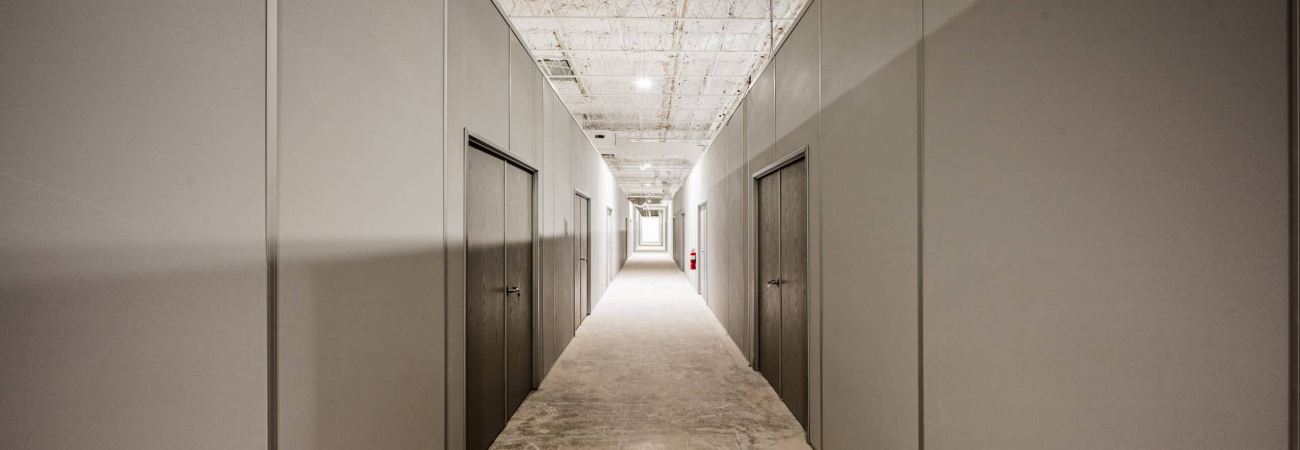 Hallway with modular partition walls and integrated doors by Allied Modular.
