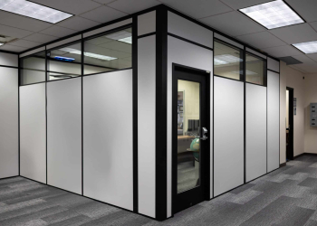 Modular office enclosure built by Allied Modular featuring black-framed panels with glass upper sections and a glass door.