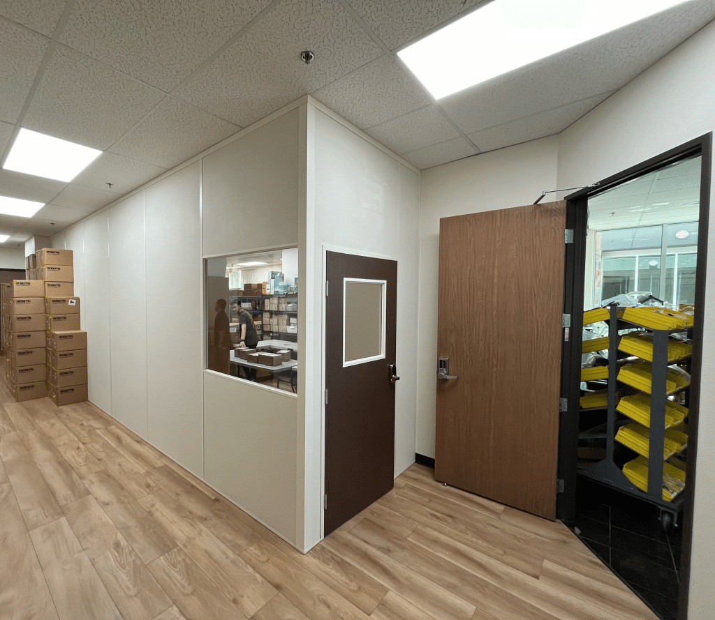 Interior view of an Allied Modular temporary office building with vinyl-wood-plank flooring and panelized walls.