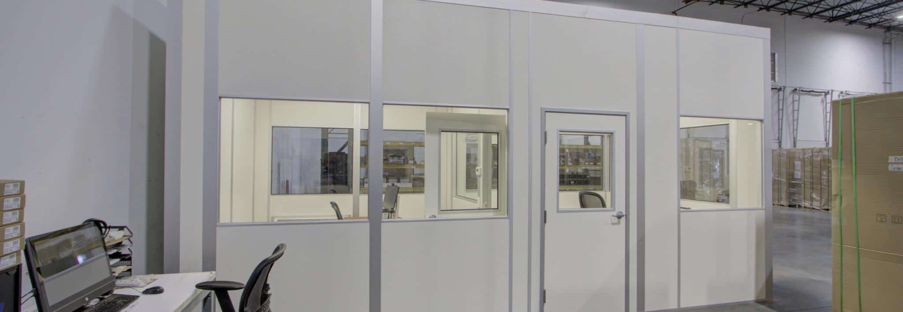 Allied Modular prefabricated inplant office with windows and a door inside a warehouse facility.