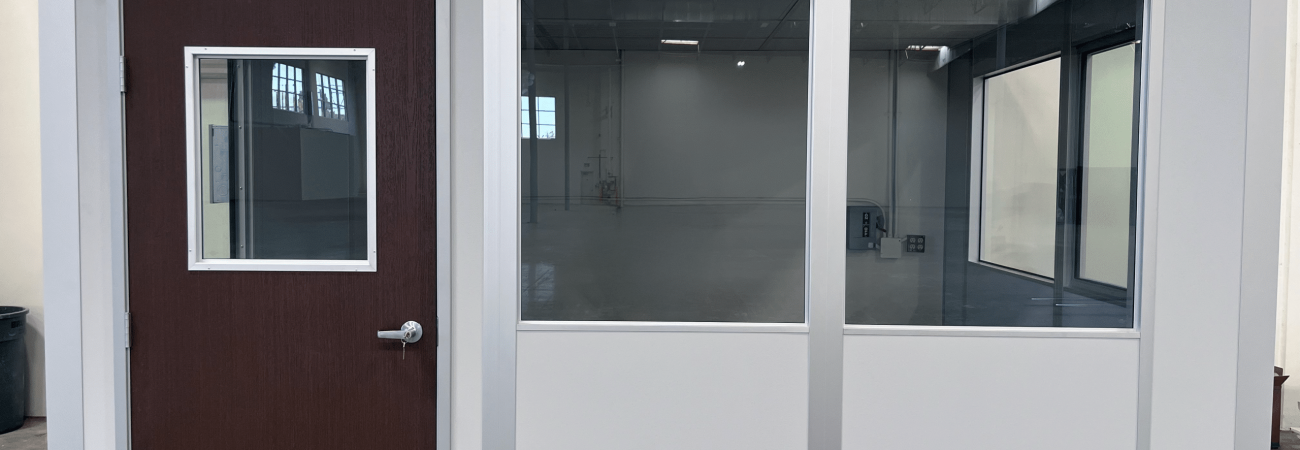 Modular office with glass panels and wood door by Allied Modular